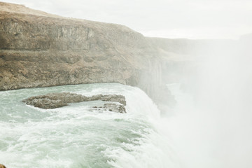 View of a large waterfall in Iceland. June summer day near the raging mountain river and waterfall