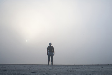 Man disappearing in the white fog