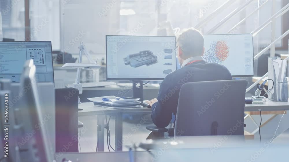 Poster Back View of Industrial Engineer Working on Desktop Computer in Bright Office. Screens Show IDE / CAD Software, Implementation of Machine Learning, Neural Networking and Cloud Computing