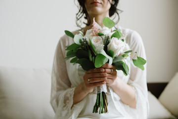 The bride holds a wedding bouquet, close up