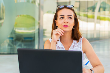 young woman with laptop in cafe