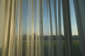Fototapeta na wymiar sunlight in morning day through white curtain on window