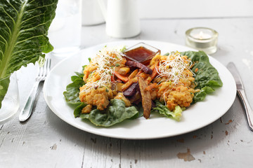 Vegetable fries with vegetable stew on iceberg lettuce.