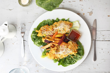 Baked vegetables, sweet potato, potato, celery, carrot, beet served with vegetable stew on iceberg lettuce.
