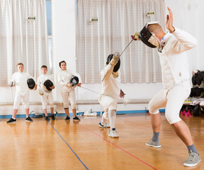 Fototapeta premium Two fencing instructors showing effective techniques