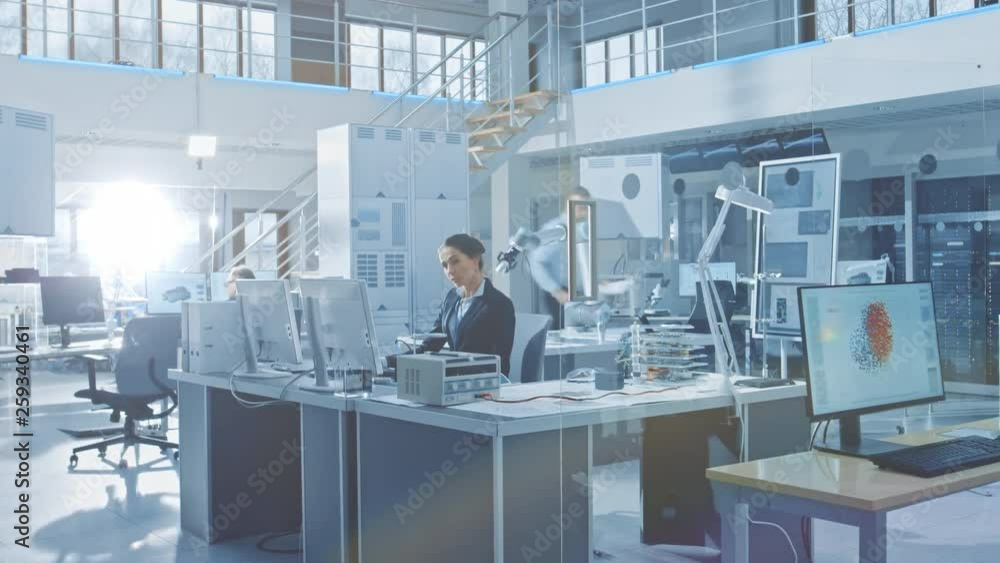 Poster Time-Lapse of the Bright Industrial Robotics Technology and Design Office where People Work on Computer, Program and Manipulate Robot Arm. Engineers Working in Research Facility