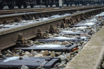 Railroad station in winter time with old tracks