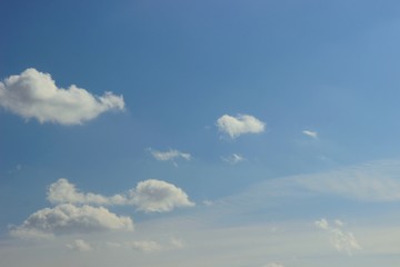 Spring bright blue sky with small clouds in the sun rays. Breathing in the fresh air the approach of spring. the concept of ecology of life
