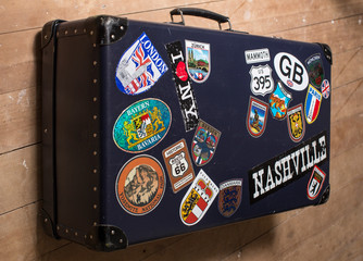 Vintage suitcase with travel decals