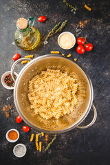 Fusilli pasta in a stainless steel colander