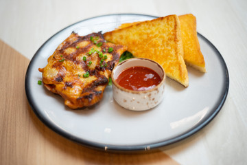 Chicken Grilled steaks and bread on table
