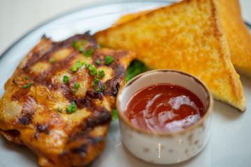 Chicken Grilled steaks and bread on table