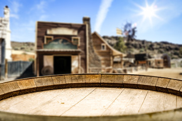 Wooden old table of free space for your product. Blurred background of Wild West city in America. 
