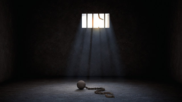 ball and chain for prisoner in jail with broken prison bars, prison escape or jailbreak concept