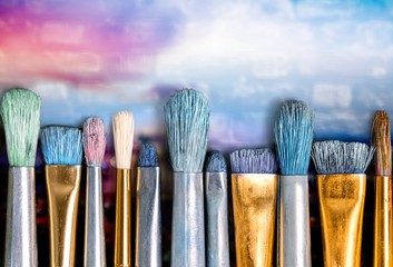 Row of artist paint brushes  on background