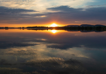 Fototapeta na wymiar Sunset on a lake in Hohenrode in Germany