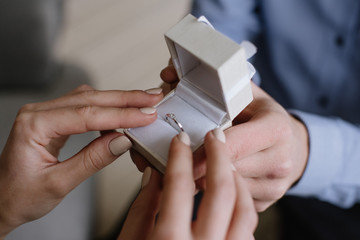 Men and women with proposal ring holding their hands. close up