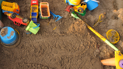 Top of view of a sandbox with toys on playground in sunny day