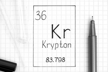 Handwriting chemical element Krypton Kr with black pen, test tube and pipette.