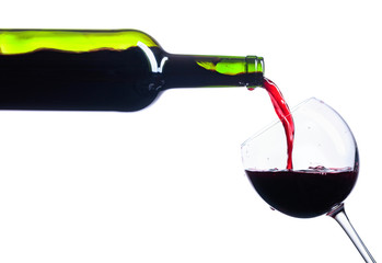  Pouring red wine from bottle to glass isolated on white.