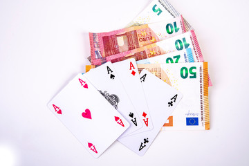 four playing card asses with euro banknotes game winnings