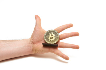Fototapeta na wymiar Bitcoin coin made of wood in male hands on white background