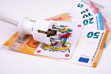 Electric plug with Joker playing card and Euro banknotes