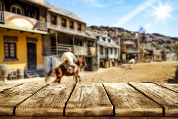 Wooden old table of free space for your decoration and Wild West background. 