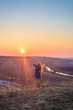 the girl in the sunset. vertical image