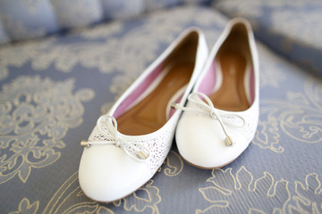 Bride's white flat wedding shoes