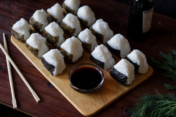 Onigiri traditional Japanese dish with soy sauce served on the table