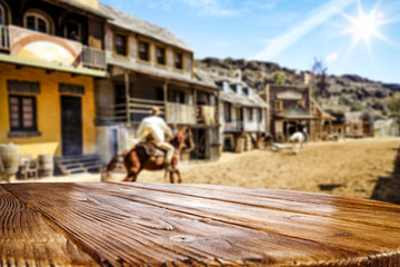 Wooden old table of free space for your decoration and Wild West background. 