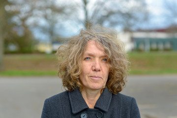 Portrait of middle aged woman in coat outdoors