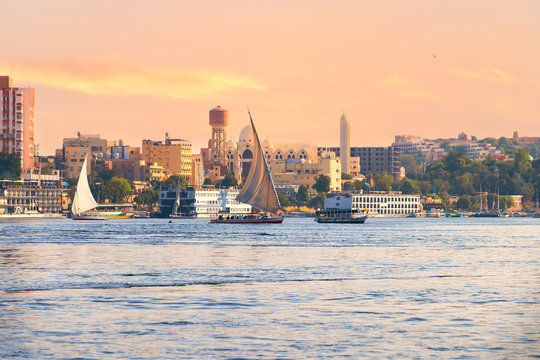 Falucas boat and motor boats sailing in Nile river at sunset
