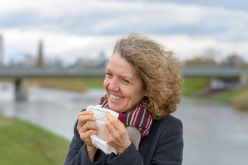 Smiling attractive woman holding a white tissue