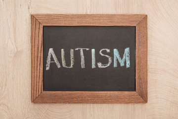 top view of chalkboard with autism lettering on wooden table
