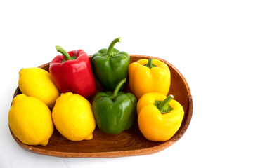 colerful bell peppers and lemon on white background