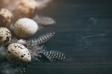 Quail eggs on old wooden background. Happy Easter. Top view. Free copy space. Selective focus.