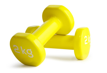 Two yellow  dumbbells isolated on white background with clipping path