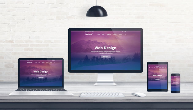 Web design, developer studio concept with responsive web page on multiple displays.