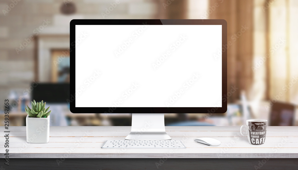 Poster computer display mockup. modern studio work desk with plant, keyboard, mouse and cup of coffee.