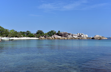 Fototapeta na wymiar Tanjung Tinggi Beach on a sunny day in Belitung Island, Indonesia
