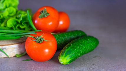 Fresh vegetables and greens for salad on a wooden surface. The concept of a healthy diet.