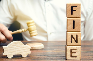 Wooden blocks with the word Fine, wooden car and judge. Violation of traffic laws. Penalty as a...