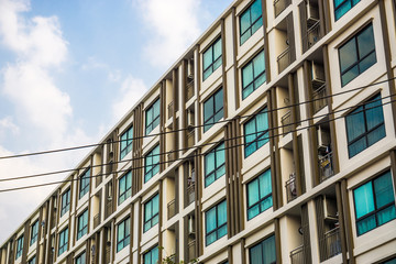 Modern condominium block building with blue sky cloud real estate