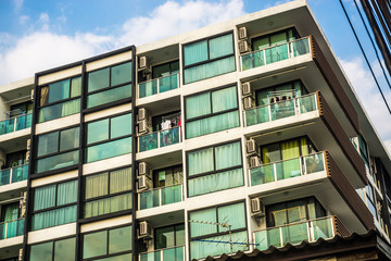 Obraz premium Modern condominium block building with blue sky cloud real estate