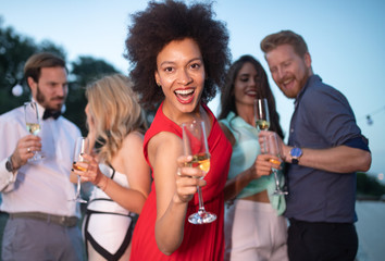 Group of happy people or friends having fun at party