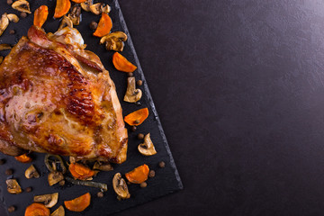 Thigh turkey baked in the oven with spices on black stone background. Healthy food. Thanksgiving...