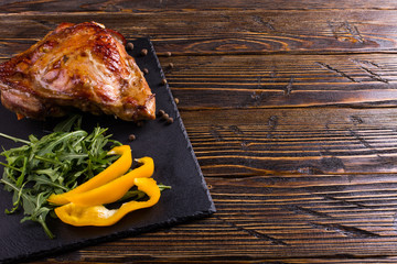 Thigh turkey baked in the oven with spices on black stone board. Healthy food. Thanksgiving dinner.