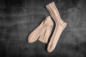 white knitted socks on a black and gray wooden background